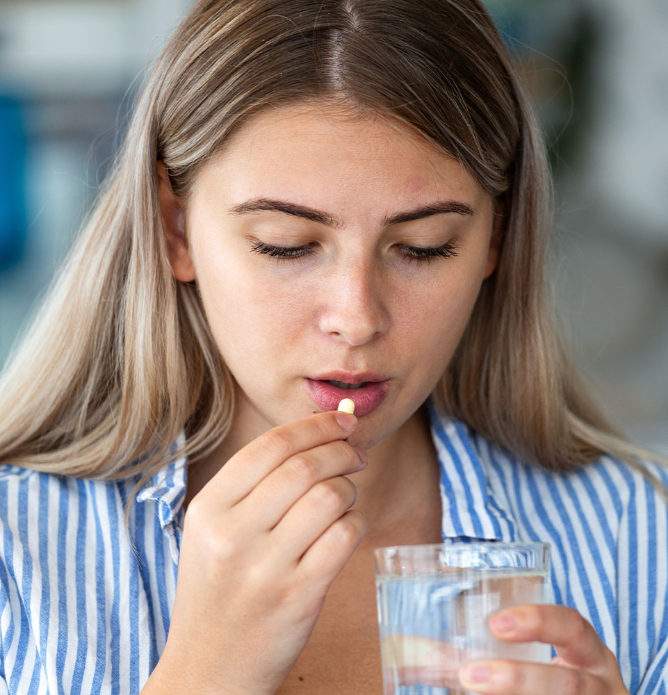 person taking pill for sedation